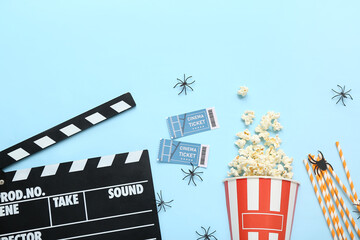 Sticker - Composition tasty popcorn, clapperboard and cinema tickets on blue background. Halloween celebration