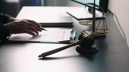 Poster - Young lawyer in office Businessman and lawyers discussing contract papers with brass scale on wooden desk in office. Law, legal services, advice, Justice and real estate concept.