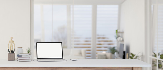 Wall Mural - a modern home workspace with a laptop mockup on a table in a white living room