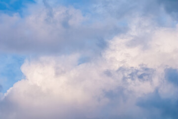 Wall Mural - blue sky background with white and pink clouds at sunset