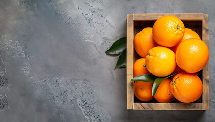 Poster - Fresh orange fruits in wooden box on stone table. Top view with copy space