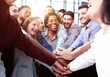 © Katsiaryna - Large business team showing unity with their hands together