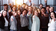 © Katsiaryna - Large Group of people standing together in studio showing thumbs up