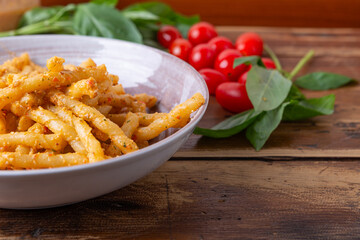 Wall Mural - Sicilian pasta with almond and tomatoes pesto. Typical Italian food from Sicily, pasta with red pesto.