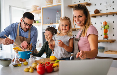 Wall Mural - Happy family preparing healthy food together in kitchen. People happiness cooking concept