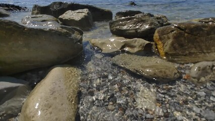 Poster - Large stones on the seashore in summer.