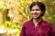 © Wavebreak Media - Portrait of happy indian man in sunny nature, copy space