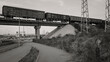 Freight wagons on the railway bridge. Freight train. Transportation concept. Black and white. Ust-Kamenogorsk (kazakhstan)