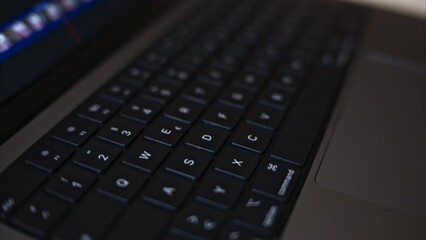 Close up black notebook keyboard with illuminated buttons