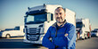 Happy old Truck Driver standing in front of a white cargo truck. Transportation Logistic Business Industry Concept Banner Background 