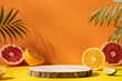 Empty wooden round podium on colorful yellow and orange background surrounded by citrus fruits. Display, pedestal for the presentation of cosmetic products, drinks