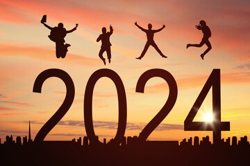 Group silhouette of businessman and businesswomen jumping together celebrating for the new year 2024
