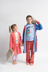 Wall Mural - Children - brother and sister in pajamas with pillows in their hands. Boy and girl.