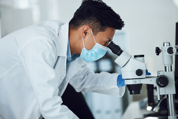 Leinwandbilder - Microscope, science and asian man with face mask in laboratory for research, medical analysis and biotechnology. Scientist, microbiology and investigation of innovation, dna testing and development