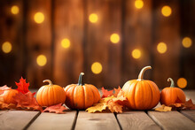 Thanksgiving Background. Pumpkin And Dry Leaves On Rustic Wooden Table With Light Bokeh Background. Autumn And Fall Background. Holiday Autumn Festival. Thanksgiving And Harvest Concept.