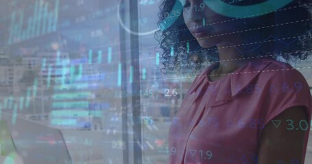 Poster - Animation of multiple graphs and trading board over biracial woman standing and working on laptop