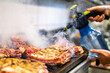 © pavel siamionov - chef cooking pork ribs on grill in kitchen