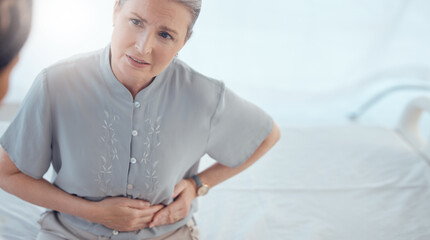 Healthcare, senior and woman with a doctor and pain from the appendix for a consultation. Stomach pain, hospital and elderly clinic patient speaking to medical professional about an injury or problem