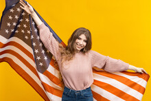 The American Flag And The Woman's Beauty Come Together Beautifully In This Photo, Standing Out Against The Bold Yellow Background And Leaving A Lasting Impression