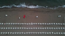 Aerial View Of An Empty Beach At Dawn With Parasols Along The Coastline, Capaccio, Paestum, Campania, Italy.