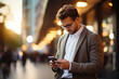 © arhendrix - Close-up image of businessman watching smart mobile phone device outdoors. Business man networking typing an sms message in city street.