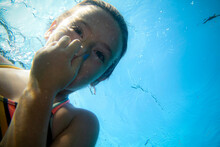 Underwater View Of Girl Holding Breath In Lake