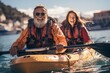 © Salsabila Ariadina - Happy retired couple enjoying travel moment paddling on kayak