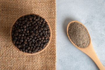 Ground black pepper with grains of black pepper,top view