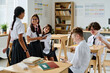 © AnnaStills - Group of school children talking to each other during break at school
