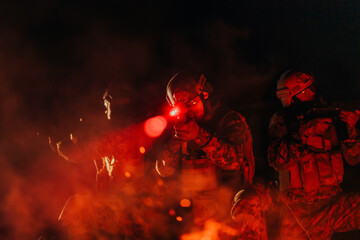 Soldiers squad in action on night mission using laser sight beam lights military team concept