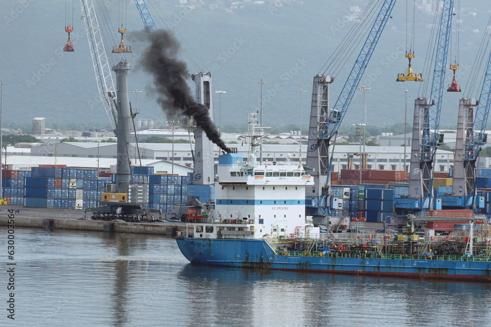 Black smoke as air pollution coming out from funnel of tanker vessel ...