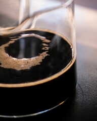 Sticker - coffee in a glass on a table with a small saucer