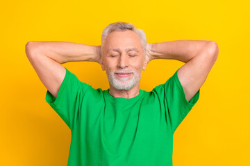 Poster - Portrait of satisfied carefree person closed eyes arms behind head enjoy nap sleep isolated on yellow color background