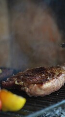 Sticker - Closeup vertical video of a piece of juicy steak and vegetables are grilled