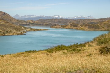 Poster - Aerial view of lake surrounded by mountains and grass