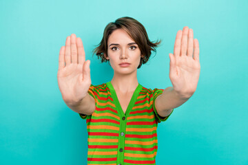 Canvas Print - Portrait of serious focused girl arms palms demonstrate stop enough you gesture isolated on turquoise color background