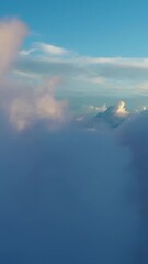 Wall Mural - flying above the clouds. aerial view of clouds at sunrise. traveling by air perfect background. vert