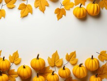 Minimalistic White Background With Pumpkins And Autumn Yellow Leaves.
