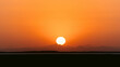 © Travel 'n' Lifestyle - Epic sunset landscape sky with big bright sun going behind the mountains in Egypt.