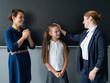 © Михаил Решетников - The teacher praises the schoolgirl in front of her mother standing at the blackboard.