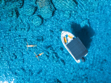 Aerial View Of Alone Small Motorboat And Swimming People In The Sea In Summer Sunny Day. Beautiful Oludeniz, Turkey. Top Drone View Of Bay, Boat, Family, Transparent Blue Water, Sand, Travel. Vacation