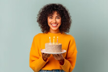Happy  Young Woman In Warm Sweater Smiling And Holding Birthday Cake With Candle  