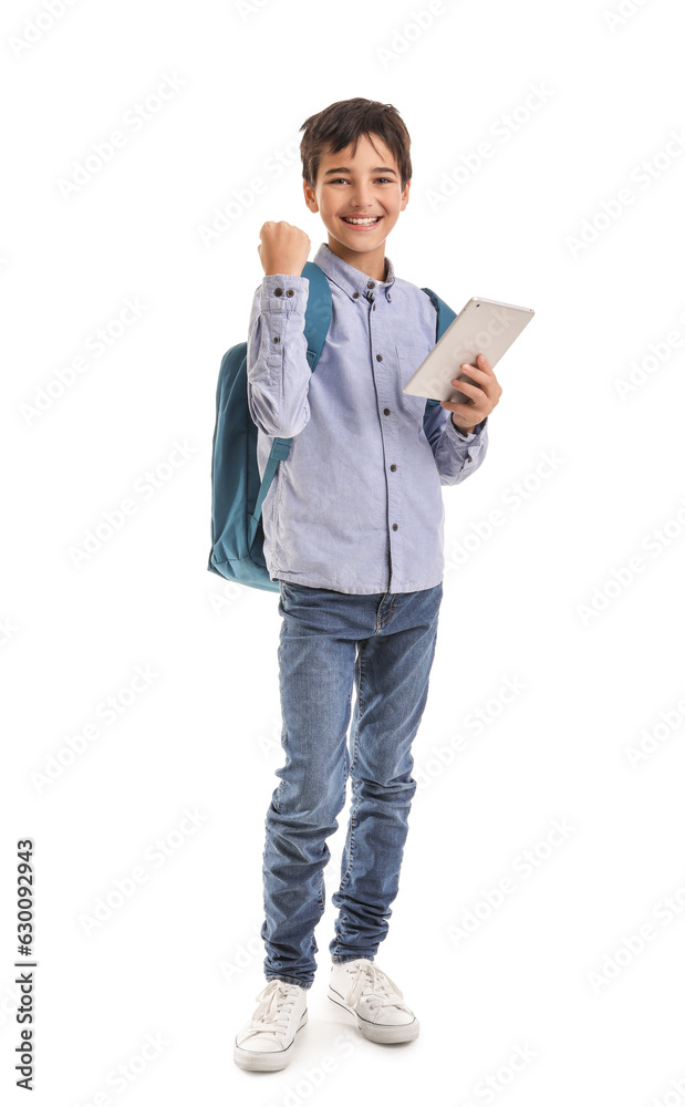 Happy little schoolboy with tablet computer on white background