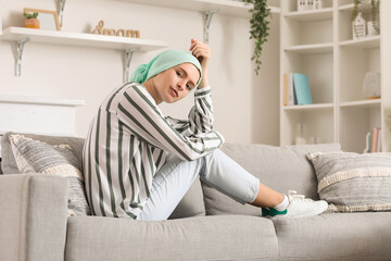 Sticker - Teenage girl after chemotherapy sitting on sofa at home