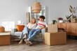 © Pixel-Shot - Young couple sitting in room on moving day