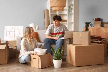 Sticker - Young couple using laptop in room on moving day