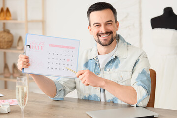 Poster - Male wedding planner with Save the Date announcement in office