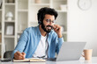© Prostock-studio - Online Education. Indian Smiling Man In Headset Study With Laptop At Home