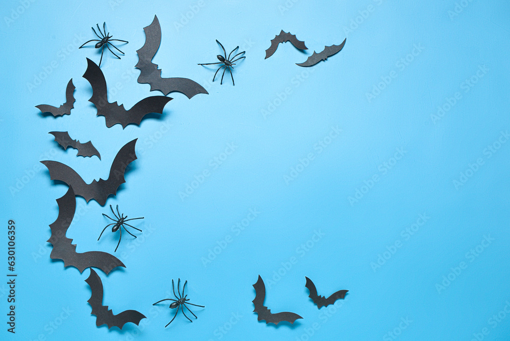Paper bats and spiders for Halloween party on blue background