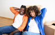 © Prostock-studio - Young Smiling Black Couple Relaxing On Floor On Moving Day